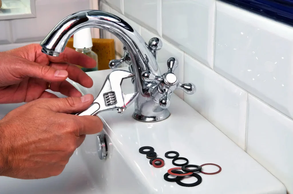 Plumber performing maintenance on a bathroom faucet in Miami Beach