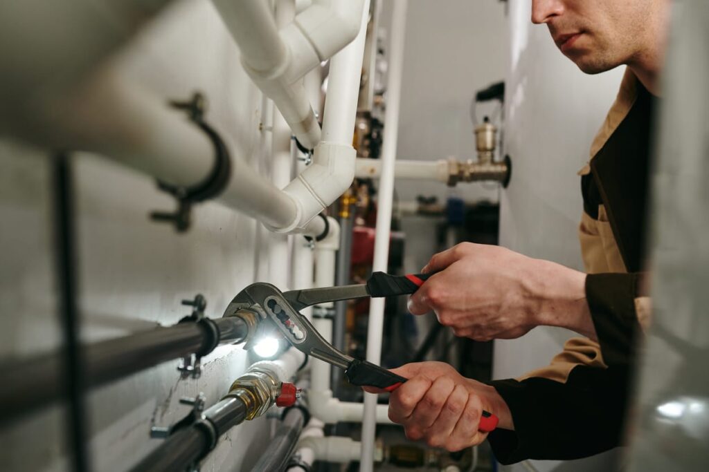 Plumbers maintaining commercial plumbing pipes in Miami Beach