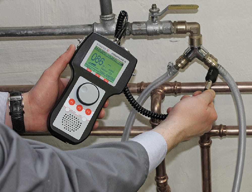 Plumber testing pipes with electronic leak detection equipment in Miami Beach
