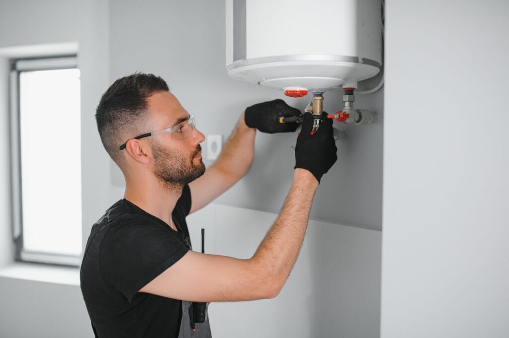 Technician performing water heater maintenance in Miami Beach